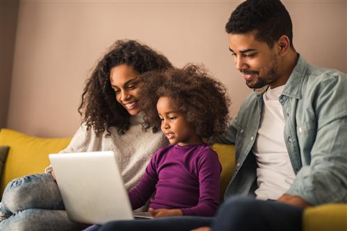 Parents with child on laptop 